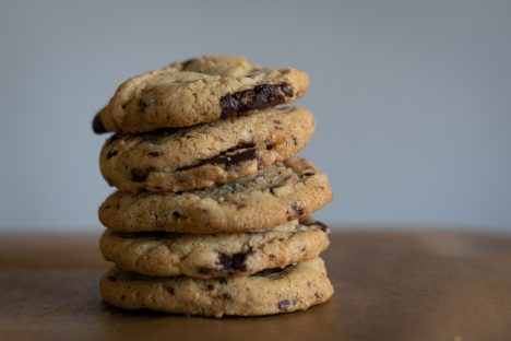 a stack of chocolate chip cookies for the cookie policy